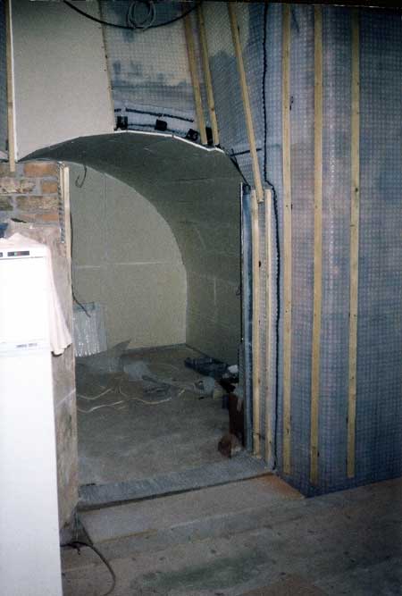 Cellar corner in the main room showing vertical battens screwed to the plug heads